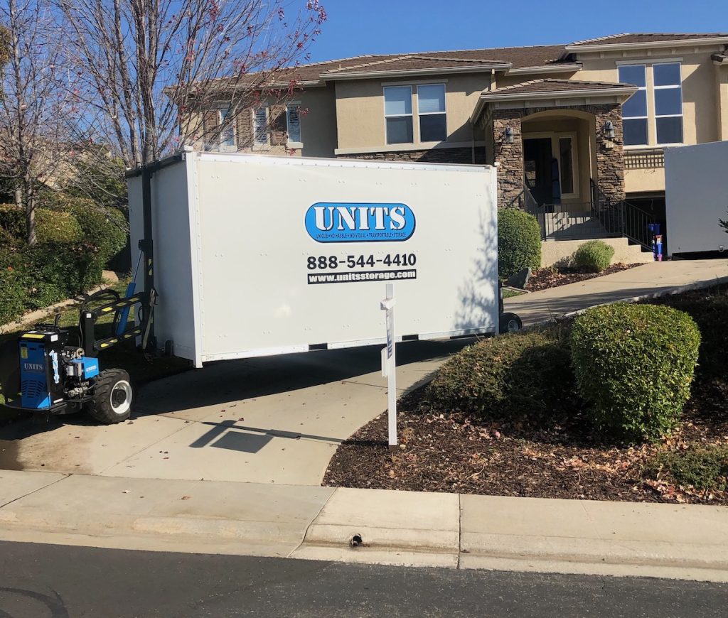 image of units portable storage container being moved in a driveway